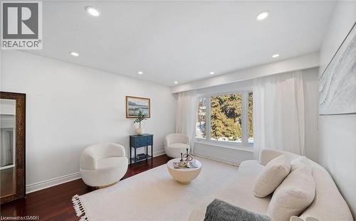 Living area featuring dark wood-style floors and recessed lighting - 1550 Woodeden Drive, Mississauga, ON - Indoor Photo Showing Living Room