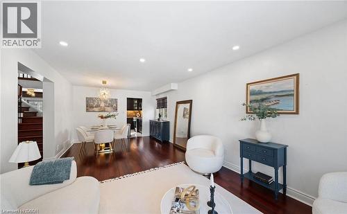 Living room featuring dark wood-style flooring and suspended lighting - 1550 Woodeden Drive, Mississauga, ON - Indoor Photo Showing Living Room