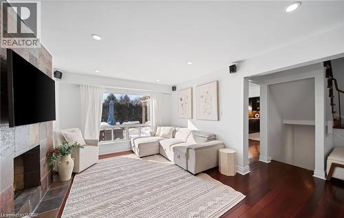 Living area featuring dark wood finished floors, a fireplace, and recessed lighting - 1550 Woodeden Drive, Mississauga, ON - Indoor Photo Showing Living Room With Fireplace