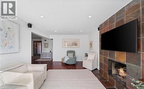 Living room with a fireplace, dark wood-style floors, and recessed lighting - 1550 Woodeden Drive, Mississauga, ON - Indoor Photo Showing Living Room With Fireplace