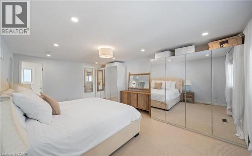 Bedroom featuring light colored carpet, recessed lighting, and a closet - 1550 Woodeden Drive, Mississauga, ON - Indoor Photo Showing Bedroom