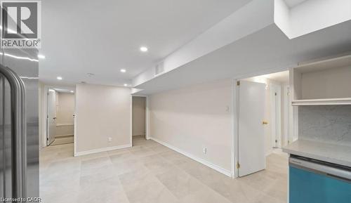Finished basement with stainless steel fridge, recessed lighting, and light flooring - 1550 Woodeden Drive, Mississauga, ON - Indoor Photo Showing Other Room