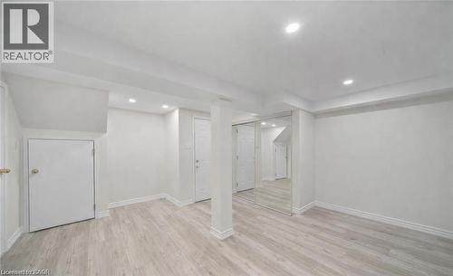 Finished basement featuring light wood finished floors and recessed lighting - 1550 Woodeden Drive, Mississauga, ON - Indoor
