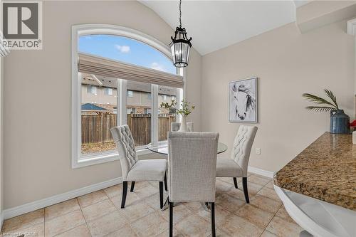 Dining room with vaulted ceiling, light tile patterned floors, and hanging lights - 100 Garinger Crescent, Binbrook, ON - Indoor Photo Showing Dining Room