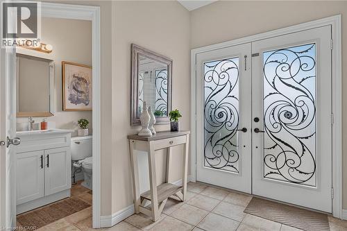 Foyer with french doors and light tile patterned floors - 100 Garinger Crescent, Binbrook, ON - Indoor Photo Showing Other Room