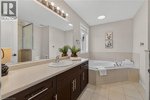 Full bathroom with a bath, vanity, a tile shower, and light tile patterned floors - 100 Garinger Crescent, Binbrook, ON - Indoor Photo Showing Bathroom