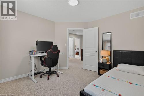 Bedroom with light carpet and a desk - 100 Garinger Crescent, Binbrook, ON - Indoor