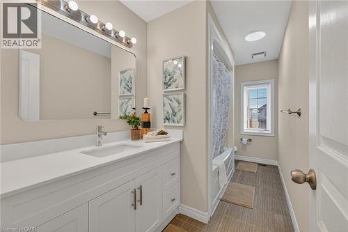 Bathroom with vanity and shower / bathtub combination with curtain - 100 Garinger Crescent, Binbrook, ON - Indoor Photo Showing Bathroom