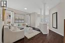 Living area featuring decorative columns, dark wood-style flooring, and recessed lighting - 100 Garinger Crescent, Binbrook, ON  - Indoor 