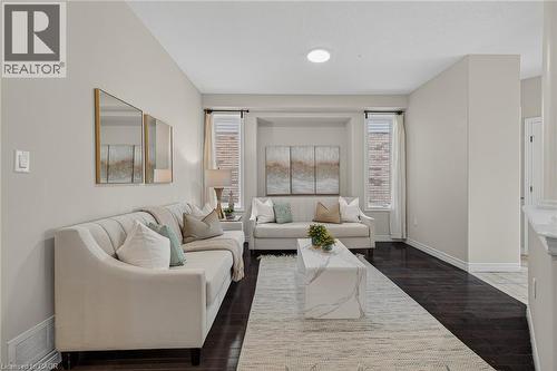 Living room featuring dark wood-type flooring and baseboards - 100 Garinger Crescent, Binbrook, ON - Indoor Photo Showing Living Room