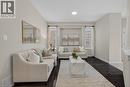 Living room featuring dark wood-type flooring and baseboards - 100 Garinger Crescent, Binbrook, ON  - Indoor Photo Showing Living Room 