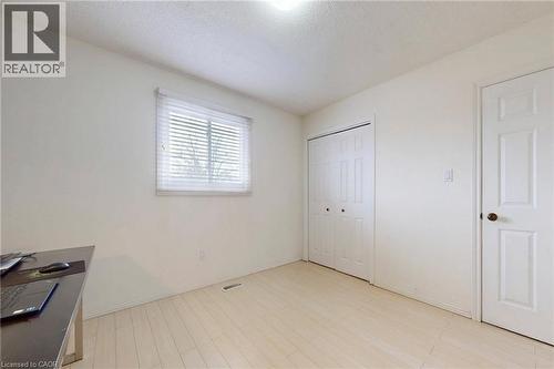 Unfurnished office featuring a textured ceiling and light wood-style floors - 62 Como Place, Hamilton, ON - Indoor Photo Showing Other Room