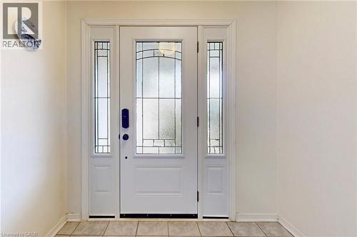 Doorway to outside with tile patterned floors and baseboards - 62 Como Place, Hamilton, ON - Indoor Photo Showing Other Room