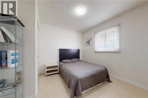 Bedroom featuring a textured ceiling and light wood finished floors - 62 Como Place, Hamilton, ON - Indoor Photo Showing Bedroom