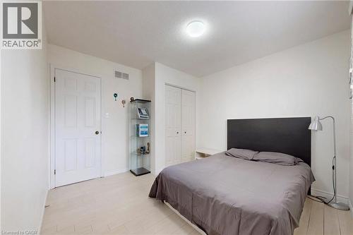Bedroom with light wood-style flooring and a closet - 62 Como Place, Hamilton, ON - Indoor Photo Showing Bedroom