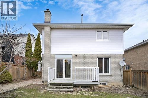 Rear view of house featuring brick siding, a fenced backyard, a wooden deck, and a chimney - 62 Como Place, Hamilton, ON - Outdoor With Exterior