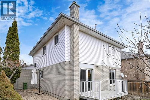 Back of property with brick siding, a wooden deck, a chimney, and a patio - 62 Como Place, Hamilton, ON - Outdoor
