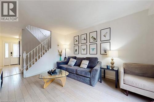 Living room with stairs and light wood-style floors - 62 Como Place, Hamilton, ON - Indoor Photo Showing Living Room