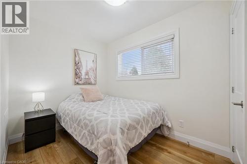 Bedroom with light wood-style flooring and baseboards - 699 Frederick Street, Kitchener, ON - Indoor Photo Showing Bedroom