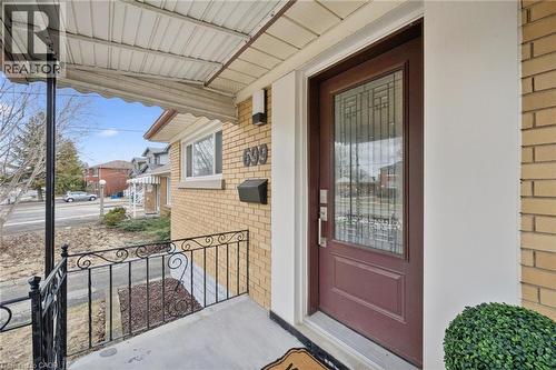 View of exterior entry with covered porch and brick siding - 699 Frederick Street, Kitchener, ON - Outdoor With Exterior