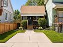 Front exterior featuring a covered porch, wood plank steps, and a dark-toned entry door - 67 Glendale Avenue N, Hamilton, ON  - Outdoor 