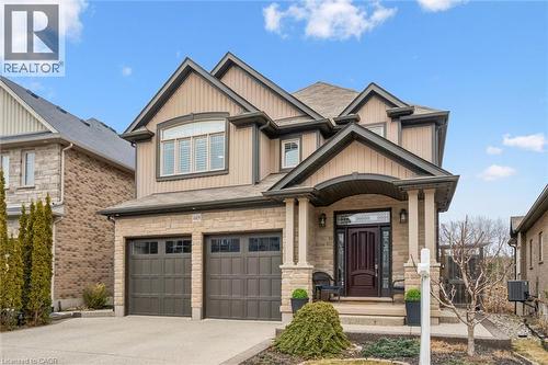 Craftsman inspired home featuring a garage, stone siding, driveway, and board and batten siding - 469 Woodbine Avenue, Kitchener, ON - Outdoor With Facade