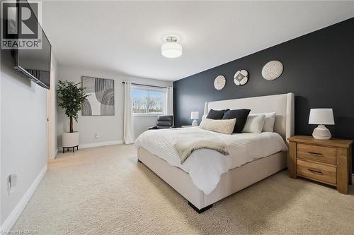 Bedroom featuring light carpet and baseboards - 469 Woodbine Avenue, Kitchener, ON - Indoor Photo Showing Bedroom