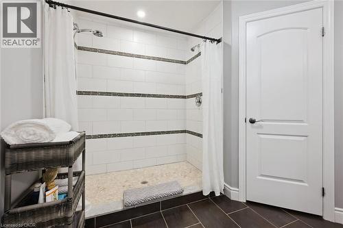 Full bath featuring a shower stall and dark tile patterned flooring - 469 Woodbine Avenue, Kitchener, ON - Indoor Photo Showing Bathroom