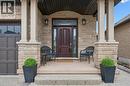 Entrance to property featuring a porch, stone siding, and a garage - 469 Woodbine Avenue, Kitchener, ON  - Outdoor 