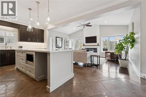 Kitchen featuring lofted ceiling, a center island, healthy amount of natural light, open floor plan, and a glass covered fireplace - 469 Woodbine Avenue, Kitchener, ON - Indoor Photo Showing Kitchen