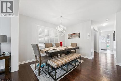 Dining room with dark wood-type flooring and a chandelier - 38 Park Glen Street, Kitchener, ON - Indoor Photo Showing Dining Room