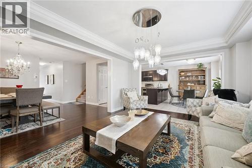 Living area featuring suspended lighting, dark wood finished floors, and crown molding - 38 Park Glen Street, Kitchener, ON - Indoor Photo Showing Living Room