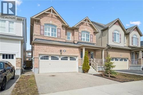 Craftsman inspired home featuring brick siding, covered porch, asphalt driveway, and an attached garage - 38 Park Glen Street, Kitchener, ON - Outdoor With Facade