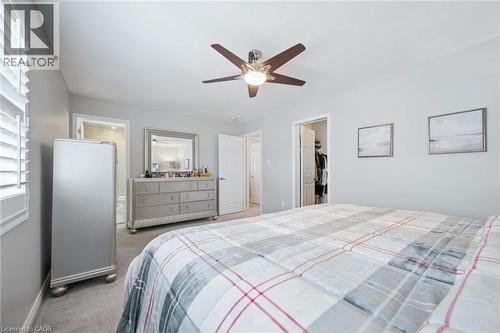 Bedroom with light colored carpet, ceiling fan, and a spacious closet - 38 Park Glen Street, Kitchener, ON - Indoor Photo Showing Bedroom