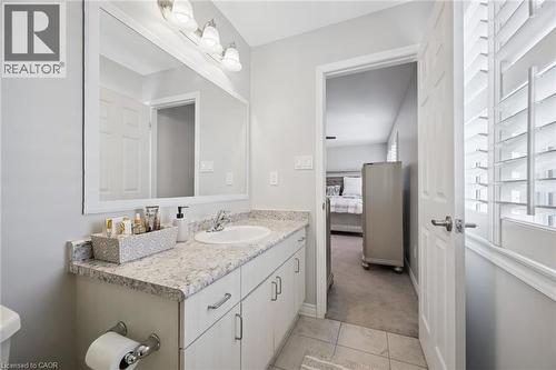 Half bath with vanity, light carpet, ensuite bathroom, and light tile patterned floors - 38 Park Glen Street, Kitchener, ON - Indoor Photo Showing Bathroom