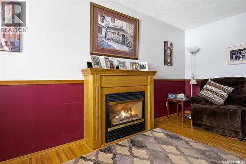 7322 Cribbs Bay, Regina, SK - Indoor Photo Showing Living Room With Fireplace