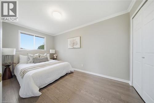 Bedroom with ornamental molding, wood finished floors, and a closet - 7 Forest Drive, Paris, ON - Indoor Photo Showing Bedroom