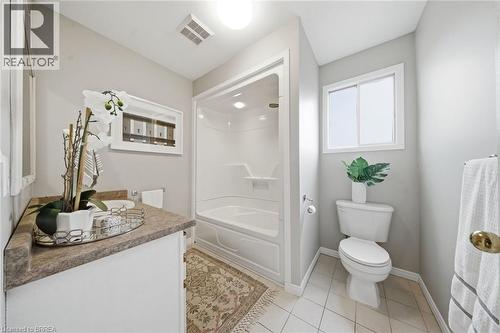 Bathroom with vanity, light tile patterned floors, and bathtub / shower combination - 7 Forest Drive, Paris, ON - Indoor Photo Showing Bathroom