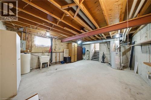 Unfinished basement with gas water heater, electric panel, and a water softener - 7 Forest Drive, Paris, ON - Indoor Photo Showing Basement