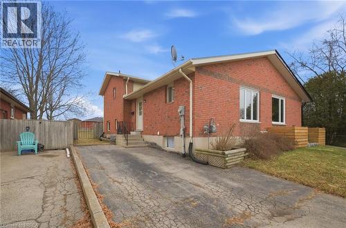View of property exterior featuring brick siding and a patio area - 7 Forest Drive, Paris, ON - Outdoor With Exterior