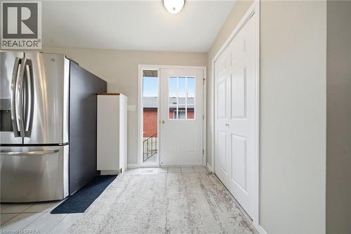 Kitchen featuring stainless steel fridge with ice dispenser and light tile patterned floors - 7 Forest Drive, Paris, ON - Indoor Photo Showing Other Room