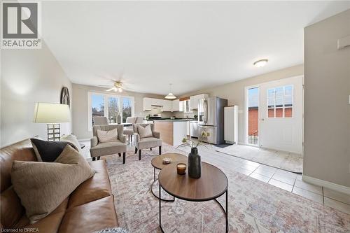 Living area with a ceiling fan and light tile patterned floors - 7 Forest Drive, Paris, ON - Indoor Photo Showing Living Room