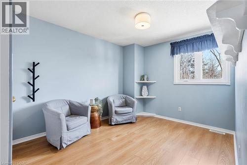 Living area with light wood finished floors and a textured ceiling - 18 Webster Way, Georgetown, ON - Indoor