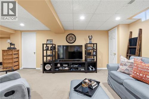 Living room with light colored carpet, a paneled ceiling, and recessed lighting - 18 Webster Way, Georgetown, ON - Indoor Photo Showing Basement