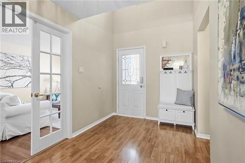 Entryway with light wood-style floors, a textured ceiling, and french doors - 18 Webster Way, Georgetown, ON - Indoor Photo Showing Other Room