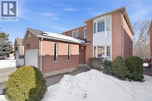 View of snowy exterior with brick siding and a garage - 18 Webster Way, Georgetown, ON - Outdoor