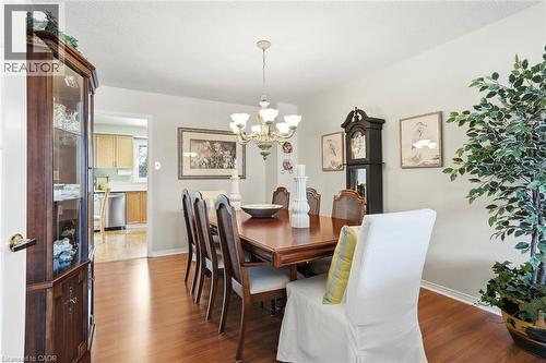 Dining room featuring wood finished floors and hanging lights - 18 Webster Way, Georgetown, ON - Indoor Photo Showing Dining Room