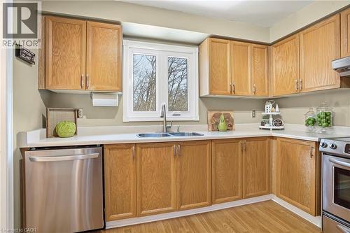 Kitchen with stainless steel appliances, light countertops, and wood finish cabinets - 18 Webster Way, Georgetown, ON - Indoor Photo Showing Kitchen With Double Sink