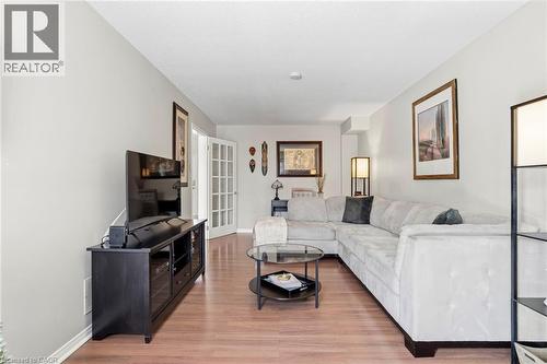 Living room featuring light wood-type flooring and baseboards - 18 Webster Way, Georgetown, ON - Indoor Photo Showing Living Room