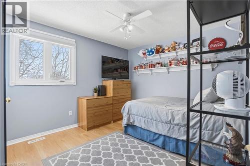 Bedroom with light wood finished floors, ceiling fan, and a textured ceiling - 18 Webster Way, Georgetown, ON - Indoor Photo Showing Bedroom